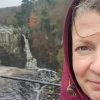 A portrait of Emma smiling with waterfalls in the background